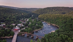 Aerial view of rural river valley community for municipal water infrastructure and local government water storage planning.